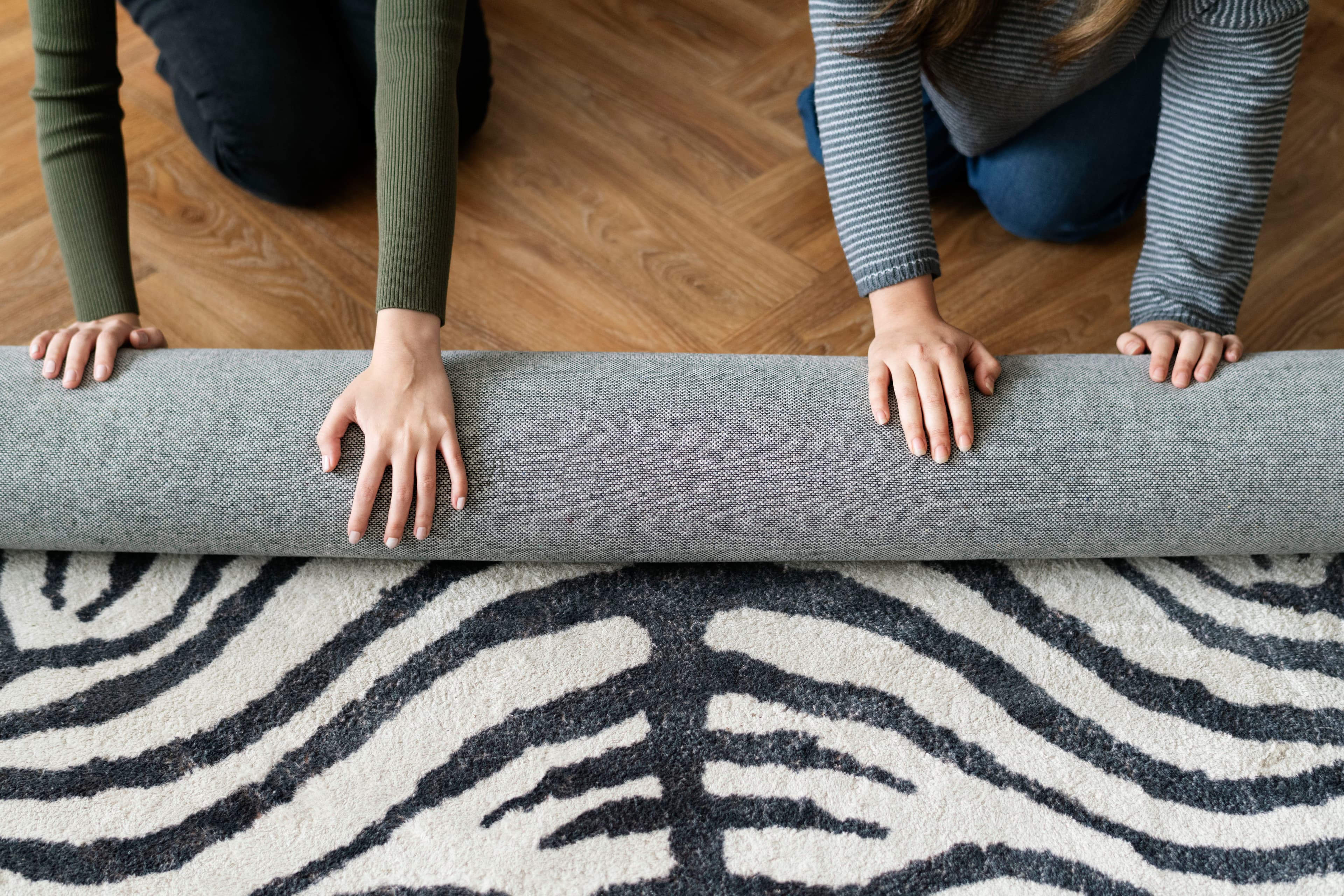 Technician cleaning a light carpet with professional equipment